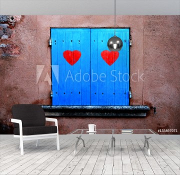 Picture of Old blue colored closed window shutters details with illustrated two red hearts